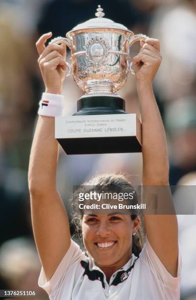 Jennifer Capriati from the United States holds the Coupe Suzanne Lenglen trophy aloft after winning the Women's Singles Final match against Kim...