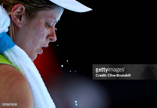 Kim Clijsters of Belgium takes a break in between games in her quarter final match against Caroline Wozniacki of Denmark during day nine of the 2012...