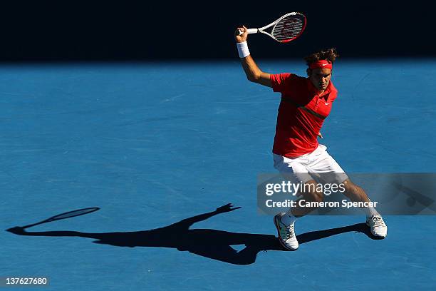 Roger Federer of Switzerland plays a backhand in his quarter final match against Juan Martin Del Potro of Argentina during day nine of the 2012...