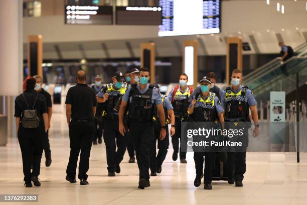 Police officers arrive ahead of international flight arrivals at the Perth International Airport Terminal on March 03, 2022 in Perth, Australia....