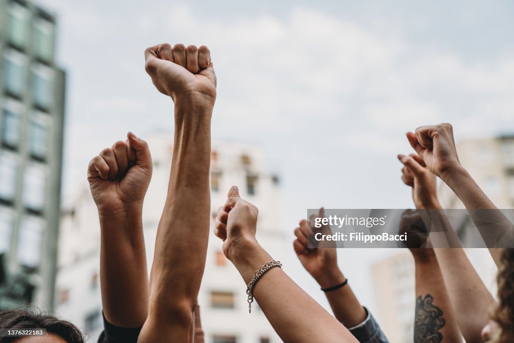 People with raised fists at a demonstration in the city