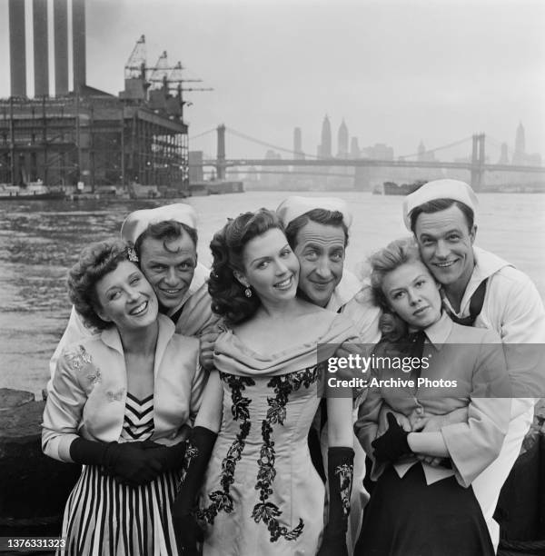 From left to right, actors Betty Garrett, Frank Sinatra, Ann Miller, Jules Munshin, Vera-Ellen and Gene Kelly pose by the river in New York City,...