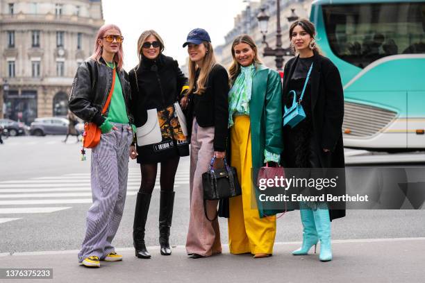 Marianne Theodorsen wears orange sunglasses, gold and silver chain pendant necklace, a yellow and green pearls necklace, a blue t-shirt, a green wool...