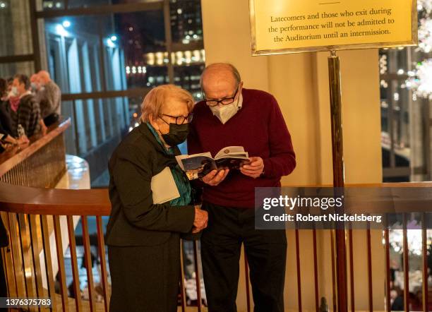 Opera goers look through the program for the performance of Richard Strauss's "Ariadne Auf Naxos" March 1, 2022 at the Metropolitan Opera at Lincoln...