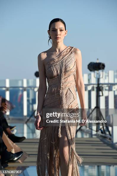 J Spring A model walks the runway at the J Spring fashion show on the Costa ...