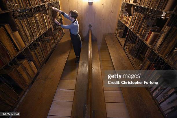 Dr Rosemary Firman, librarian of Hereford Cathedral, finishes cleaning historic manuscripts and books in the cathedral's Chained Library after it's...