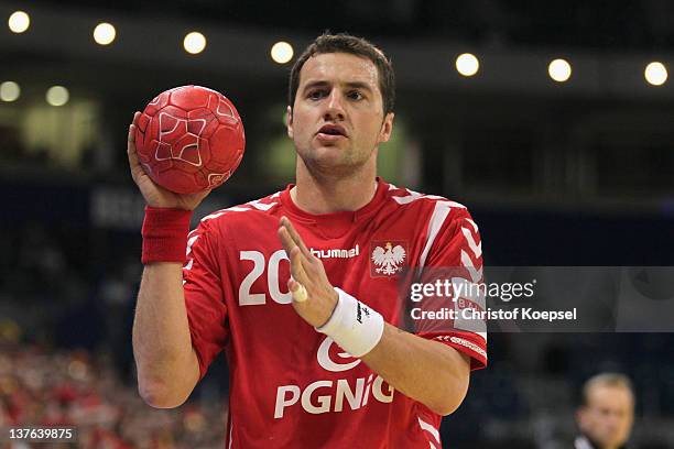 Mariusz Jurkiewicz of Poland passes the ball during the Men's European Handball Championship second round group one match between Poland and...