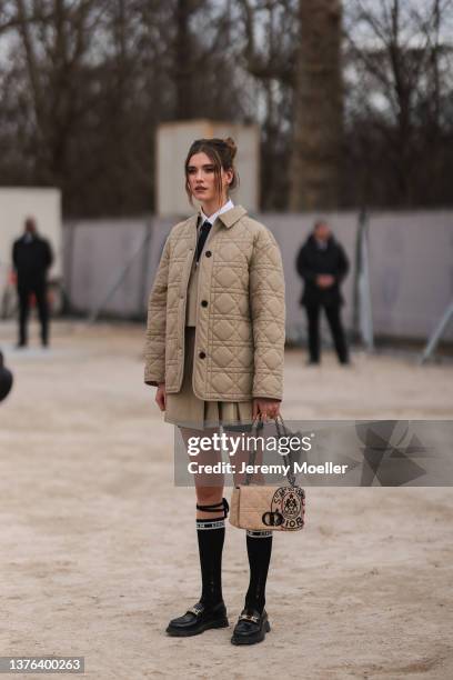 Maria Sharapova seen wearing beige puffer jacket, skirt, jacket, tie, knee high socks, loafers outside Dior during Paris Fashion Week - Womenswear...