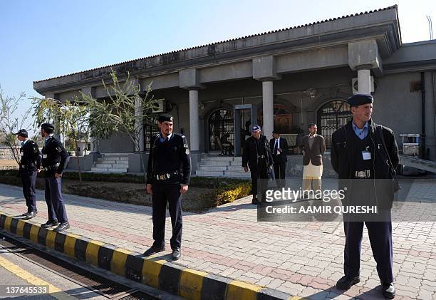 Pakistani policemen stand guard in front of the High Court building on January 24 during the judicial commission probing into a secret memo scandal....