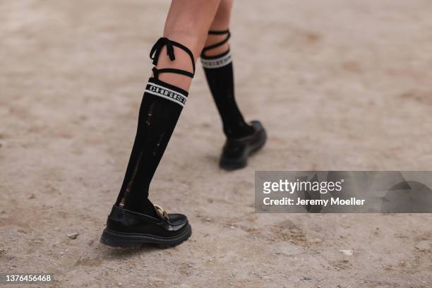 Maria Sharapova seen wearing beige puffer jacket, skirt, jacket, tie, knee high socks, loafers outside Dior during Paris Fashion Week - Womenswear...