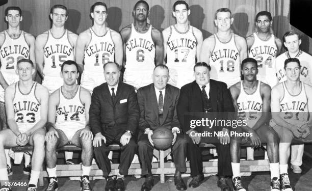 The World Champions of basketball, the Boston Celtics pose for a team portrait seated : Frank Ramsey, Bob Cousy, head coach Red Auerbach, President...