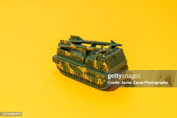 war toys on yellow background. missile launcher. - small truck bildbanksfoton och bilder