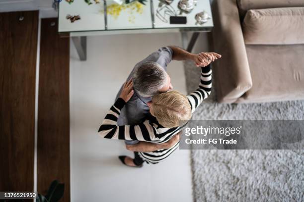 high angle view of a senior couple waltzing at home - free pictures ballroom dancing stock pictures, royalty-free photos & images