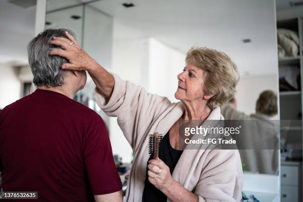 wife brushing husband's hair - supportive husband stock pictures, royalty-free photos & images