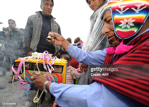 Yatiri performs a traditional ritual during the Alasitas --"buy from me" in native language-- festival to honor the Ekeko, the Aymara God of...