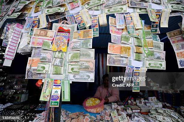 An Aymara native woman sells notes during the Alasitas --"buy from me" in native language-- festival to honor the Ekeko, the Aymara God of Abundance,...