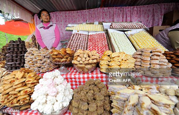An Aymara native woman sells pasteries during the Alasitas --"buy from me" in native language-- festival to honor the Ekeko, the Aymara God of...