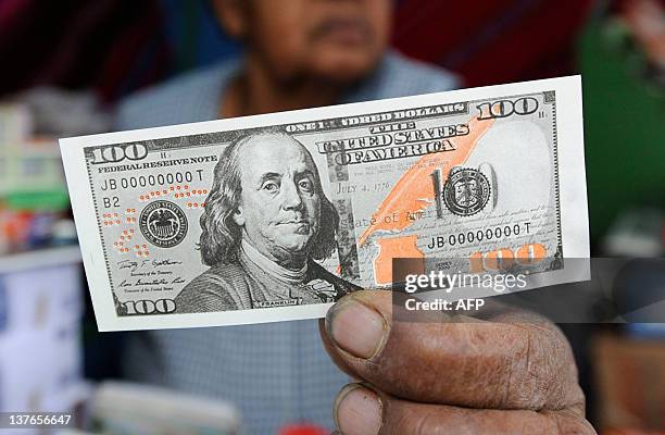 View of a miniature dollar bill during the Alasitas --"buy from me" in native language-- festival to honor the Ekeko, the Aymara God of Abundance, on...