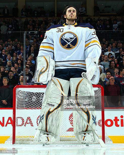 Goaltender Ryan Miller of the Buffalo Sabres stands on the ice during the singing of the National anthems prior to facing the Winnipeg Jets at the...