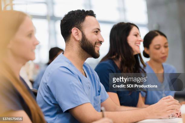 diverse class of interns listen to lecture - nurse candid stock pictures, royalty-free photos & images