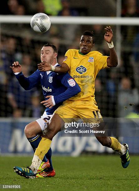 Darcy Blake of Cardiff City and Wilfried Zaha of Crystal Palace compete for the ball during the Carling Cup Semi Final second leg match between...