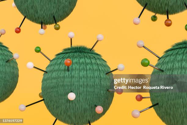 computer generated image of atom with green hairs and colored metal antennas on yellow background - neutron photos et images de collection