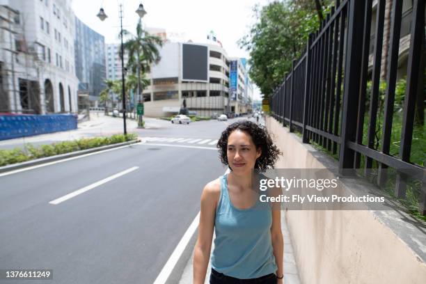 woman walking on empty city street during covid-19 pandemic - daily life in philippines stock pictures, royalty-free photos & images