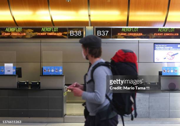 Sign reads 'Flight Cancelled' at the Aeroflot check-in counter in the Tom Bradley International Terminal at Los Angeles International Airport on...