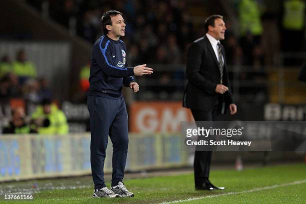 Dougie Freedman the manager of Crystal Palace reacts to events on the pitch as Malky Mackay the Cardiff City manager looks on during the Carling Cup...