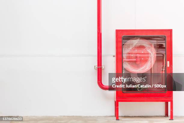 red fire hose cabinet and extinguisher - red tube stock pictures, royalty-free photos & images