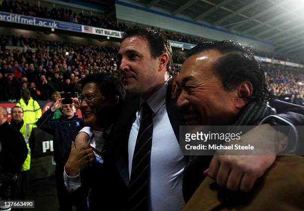 Malky Mackay the Cardiff City manager celebrates with club owner Tan Sri Vincent Tan Chee Yioun and chairman Chan Tien Ghee following his team's 3-1...