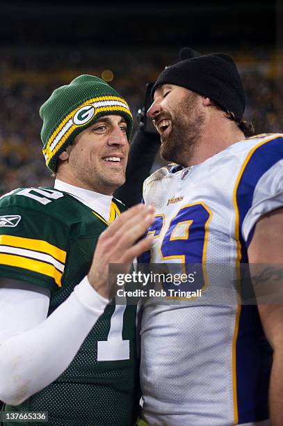 Quarterback Aaron Rodgers of the Green Bay Packers talks with defensive end Jared Allen of the Minnesota Vikings during the game against the...