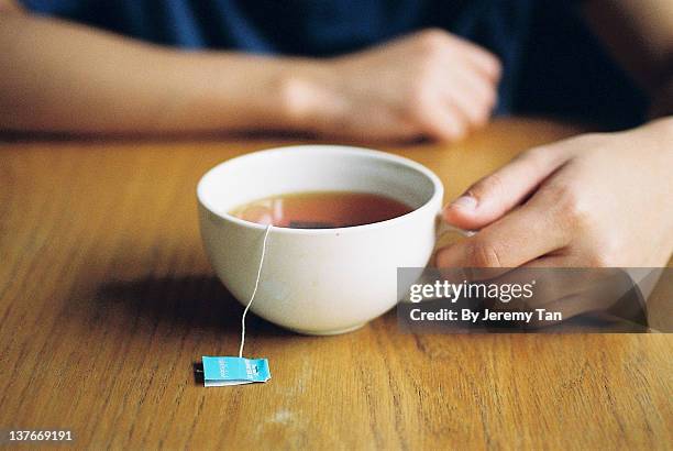 person holding morning tea cup - tea bags stock pictures, royalty-free photos & images