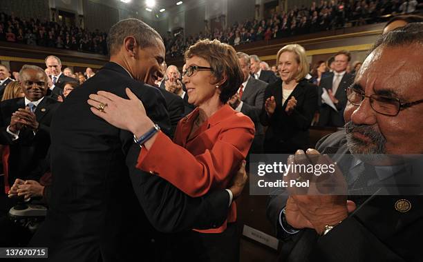 President Barack Obama embraces U.S. Rep. Gabrielle Giffords as members of Congress applaud before his State of the Union address before a joint...