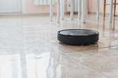 automatic remote house cleaning, robot cleaner at home on the floor
