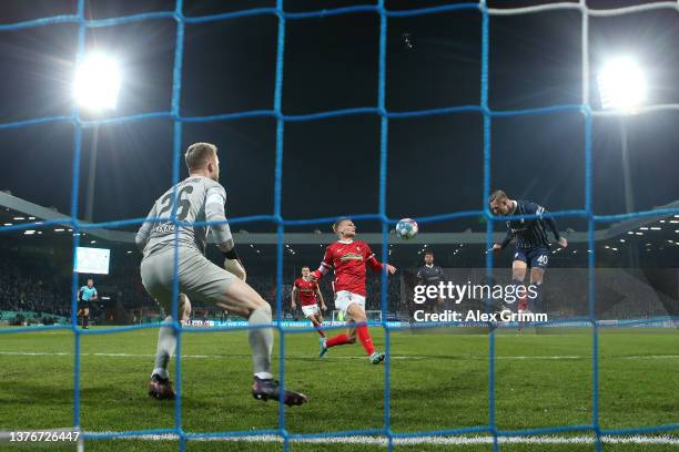 Sebastian Polter of VfL Bochum scores their team's first goal past Mark Flekken of SC Freiburg during the DFB Cup quarter final match between VfL...