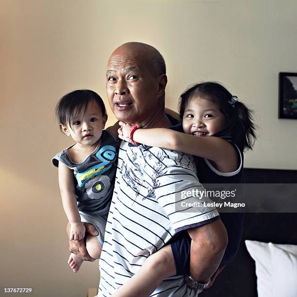 kids bonding with grandpa - filipino family stock pictures, royalty-free photos & images