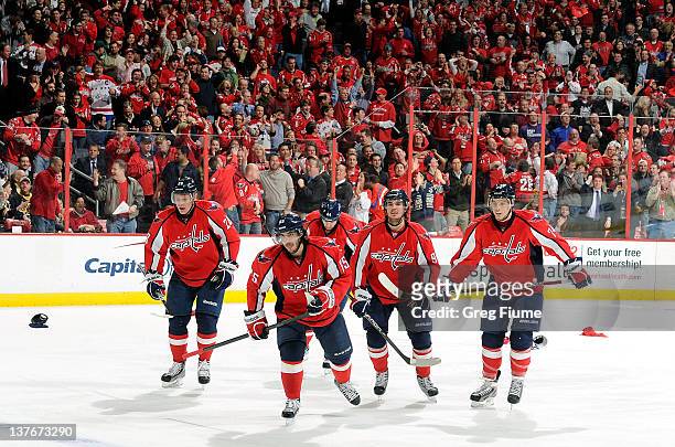 Mathieu Perreault of the Washington Capitals celebrates with teammates after scoring his third goal of the game against the Boston Bruins at the...