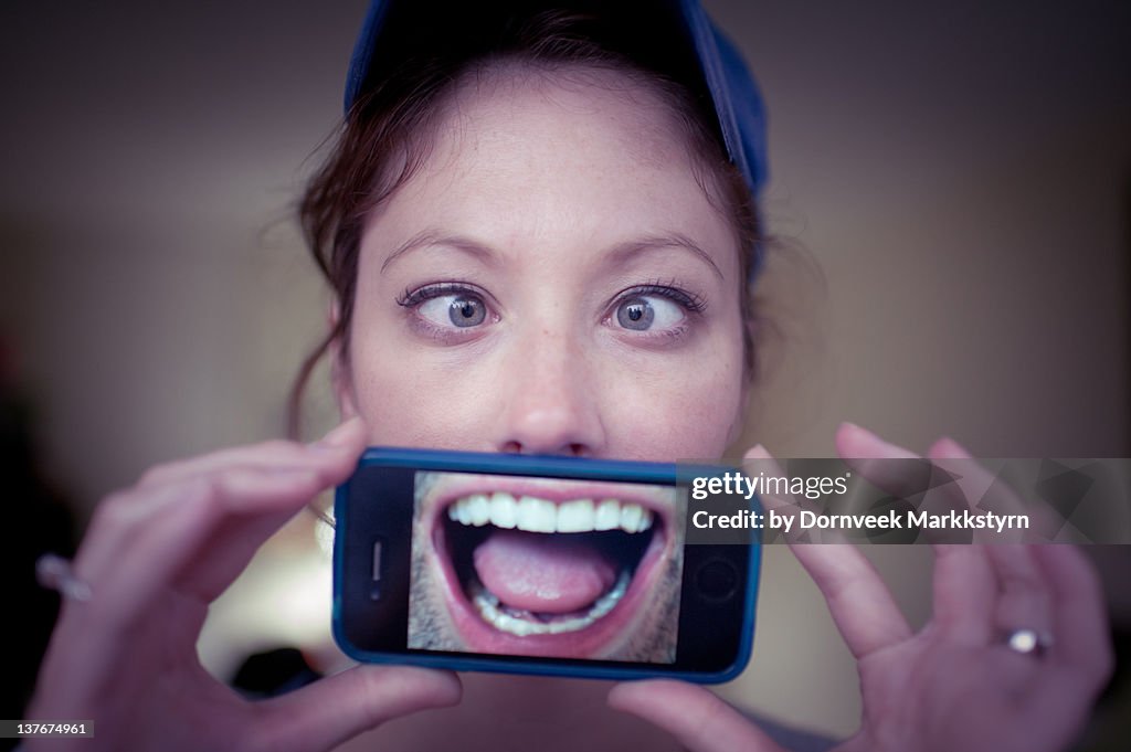 Young woman holding smartphone