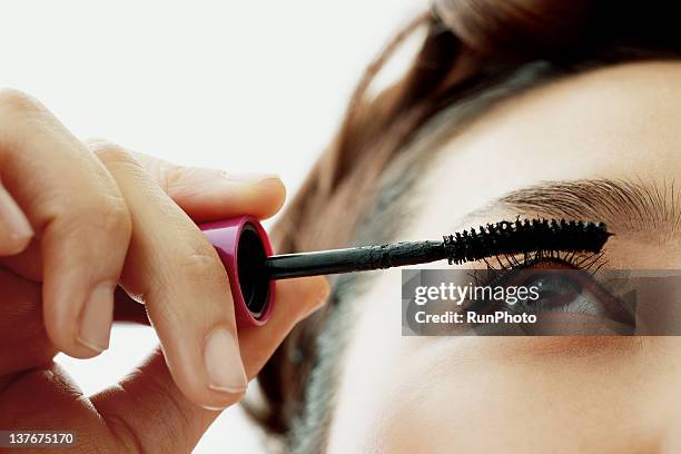 young woman applying eyelash makeup, close-up - woman mascara stock pictures, royalty-free photos & images