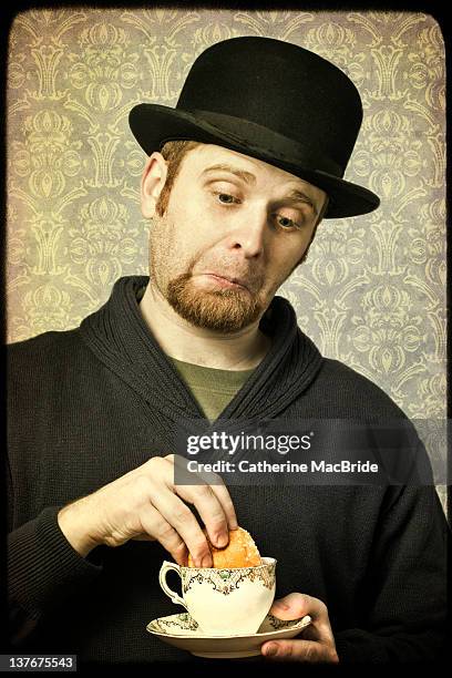 man in bowler hat with tea and cake - dips stock pictures, royalty-free photos & images