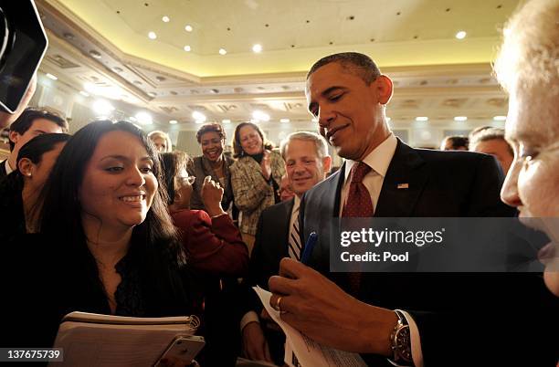 President Barack Obama signs autographs following the State of the Union address before a joint session of Congress on Capitol Hill January 24, 2012...