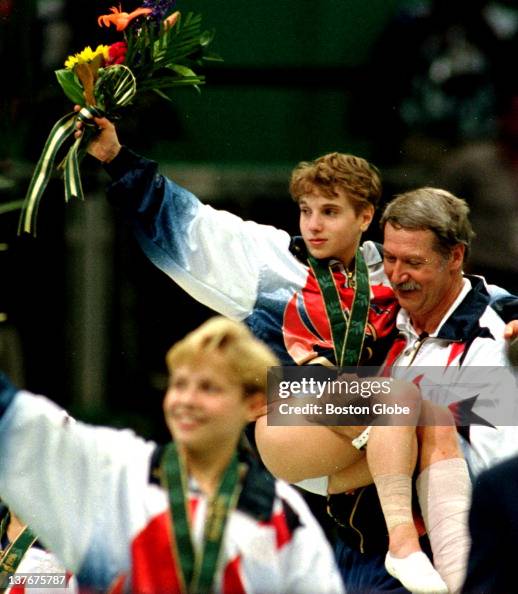 Injured gymnast Kerri Strug is carried by coach Bela Karolyi after Injured gymnast Kerri Strug is carried by coach Bela Karolyi after