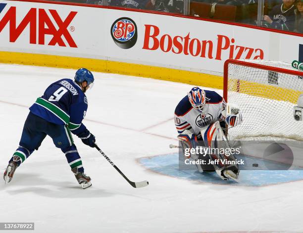 Cody Hodgson of the Vancouver Canucks scores the winning goal on Devan Dubnyk of the Edmonton Oilers in the shootout during their NHL game at Rogers...