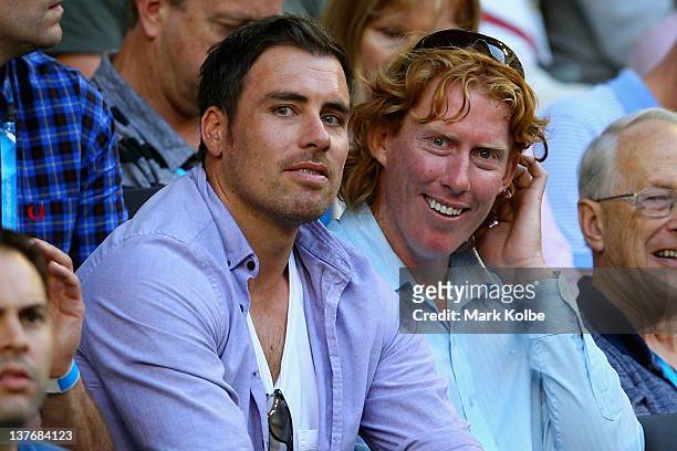 Former AFL players and current commentators Matthew Richardson and Cameron Ling watch the quarter final match between Novak Djokovic of Serbia and...