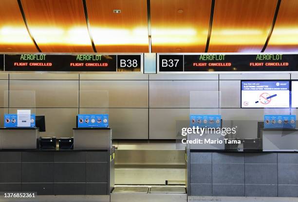 Sign reads 'Flight Cancelled' at the Aeroflot check-in counter in the Tom Bradley International Terminal at Los Angeles International Airport on...