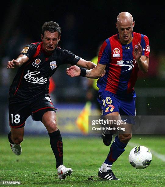 Cameron Watson of United challenges Ruben Zadkovich of the Jets during the round 16 A-League match between Adelaide United and the Newcastle Jets at...