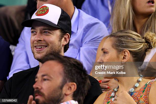 Media personality Hamish Blake and fiancee Zoe Foster watch the quarter final match between David Ferrer of Spain and Novak Djokovic of Serbia during...