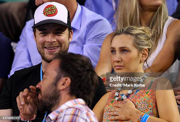 Media personality Hamish Blake and fiancee Zoe Foster watch the quarter final match between David Ferrer of Spain and Novak Djokovic of Serbia during...