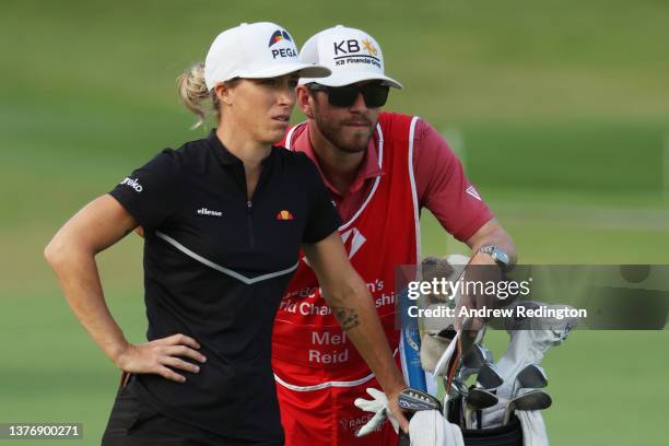 Mel Reid of England and her caddie look on from the tenth fairway during the First Round of the HSBC Women's World Championship at Sentosa Golf Club...